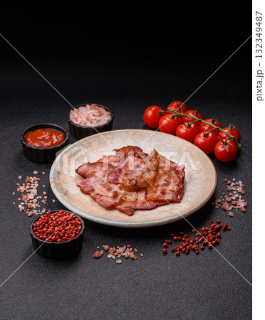 Cooked crispy fried pork bacon strips for a hearty breakfast. Fried bacon strips 132349487