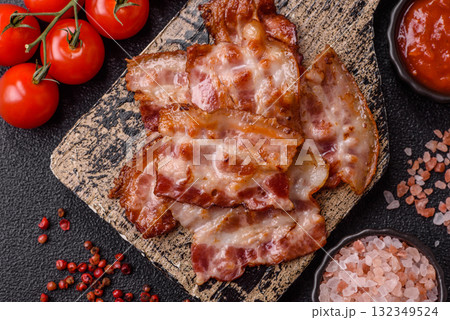 Cooked crispy fried pork bacon strips for a hearty breakfast. Fried bacon strips 132349524