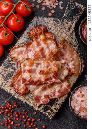Cooked crispy fried pork bacon strips for a hearty breakfast. Fried bacon strips 132349525