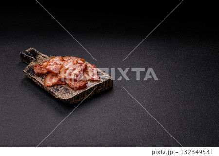 Cooked crispy fried pork bacon strips for a hearty breakfast. Fried bacon strips 132349531