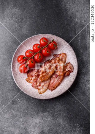 Cooked crispy fried pork bacon strips for a hearty breakfast. Fried bacon strips 132349536