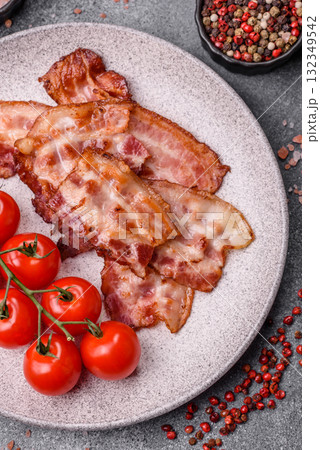 Cooked crispy fried pork bacon strips for a hearty breakfast. Fried bacon strips Cooked crispy fried pork bacon strips for a hearty breakfast. Fried bacon strips 132349542