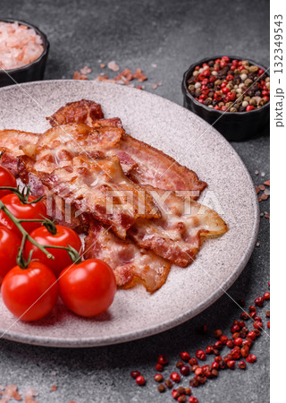Cooked crispy fried pork bacon strips for a hearty breakfast. Fried bacon strips Cooked crispy fried pork bacon strips for a hearty breakfast. Fried bacon strips 132349543