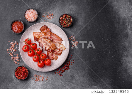 Cooked crispy fried pork bacon strips for a hearty breakfast. Fried bacon strips Cooked crispy fried pork bacon strips for a hearty breakfast. Fried bacon strips 132349546