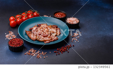 Cooked crispy fried pork bacon strips for a hearty breakfast. Fried bacon strips Cooked crispy fried pork bacon strips for a hearty breakfast. Fried bacon strips 132349561