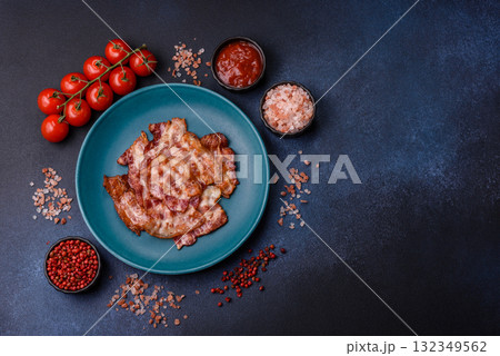 Cooked crispy fried pork bacon strips for a hearty breakfast. Fried bacon strips Cooked crispy fried pork bacon strips for a hearty breakfast. Fried bacon strips 132349562
