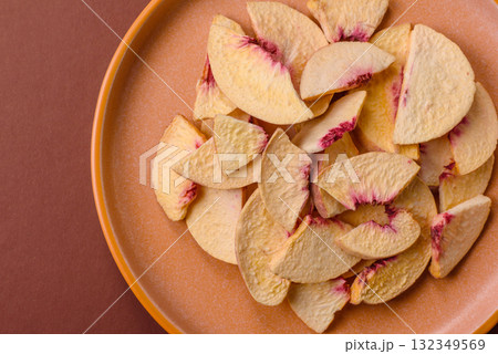 Dried sublimated slices of peach or apricot as an ingredient for sweet desserts. Dried peach Dried sublimated slices of peach or apricot as an ingredient for sweet desserts. Dried peach 132349569