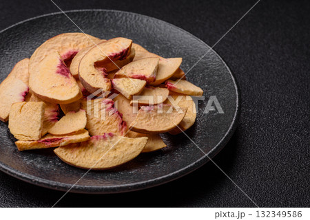 Dried sublimated slices of peach or apricot as an ingredient for sweet desserts. Dried peach Dried sublimated slices of peach or apricot as an ingredient for sweet desserts. Dried peach 132349586