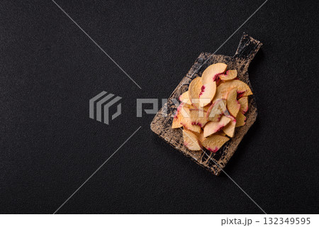 Dried sublimated slices of peach or apricot as an ingredient for sweet desserts. Dried peach Dried sublimated slices of peach or apricot as an ingredient for sweet desserts. Dried peach 132349595