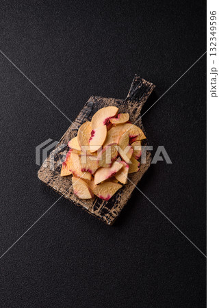 Dried sublimated slices of peach or apricot as an ingredient for sweet desserts. Dried peach Dried sublimated slices of peach or apricot as an ingredient for sweet desserts. Dried peach 132349596