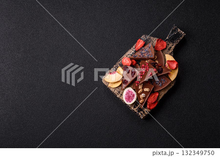Craft home made chocolate with berries and fruits, delicious sweets. Craft chocolate Craft home made chocolate with berries and fruits, delicious sweets. Craft chocolate 132349750