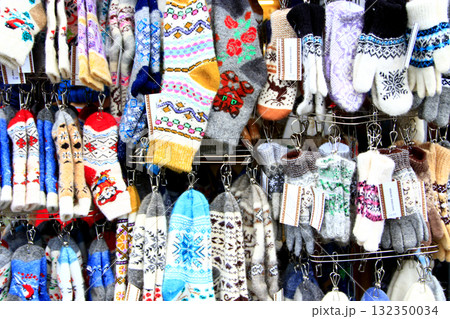Woolen mittens and socks. Rich choice of winter goods in market 132350034