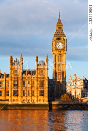 Golden sunlight illuminating the Palace of Westminster and Big Ben in London UK 132350061