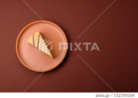 A piece of sweet New York cheesecake, dessert, cheese and vanilla pie. Classic cheesecake A piece of sweet New York cheesecake, dessert, cheese and vanilla pie. Classic cheesecake 132350109