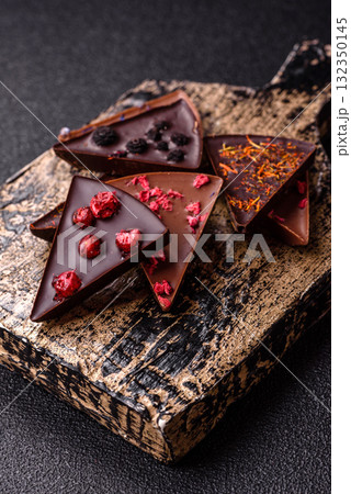 Craft home made chocolate with berries and fruits, delicious sweets. Craft chocolate Craft home made chocolate with berries and fruits, delicious sweets. Craft chocolate 132350145