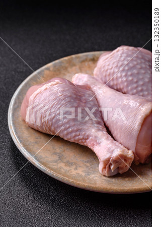Raw chicken or turkey legs as a food background for cooking on a barbecue or grill. Chicken raw legs Raw chicken or turkey legs as a food background for cooking on a barbecue or grill. Chicken raw legs 132350189