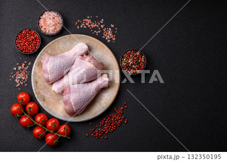 Raw chicken or turkey legs as a food background for cooking on a barbecue or grill. Chicken raw legs Raw chicken or turkey legs as a food background for cooking on a barbecue or grill. Chicken raw legs 132350195