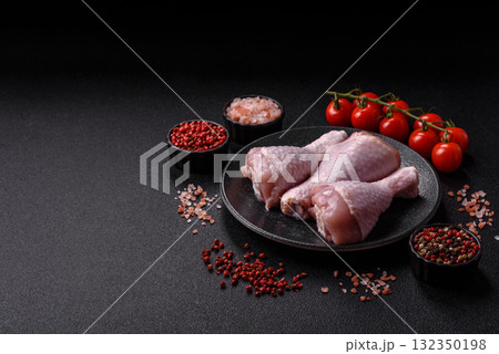 Raw chicken or turkey legs as a food background for cooking on a barbecue or grill. Chicken raw legs Raw chicken or turkey legs as a food background for cooking on a barbecue or grill. Chicken raw legs 132350198