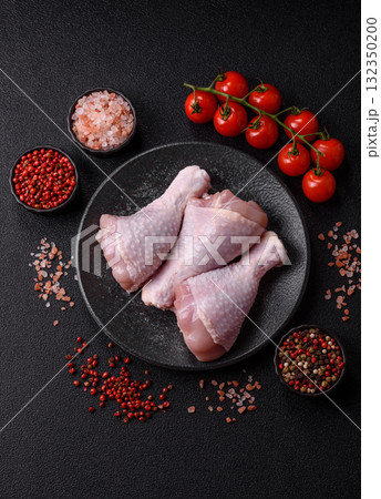 Raw chicken or turkey legs as a food background for cooking on a barbecue or grill. Chicken raw legs Raw chicken or turkey legs as a food background for cooking on a barbecue or grill. Chicken raw legs 132350200