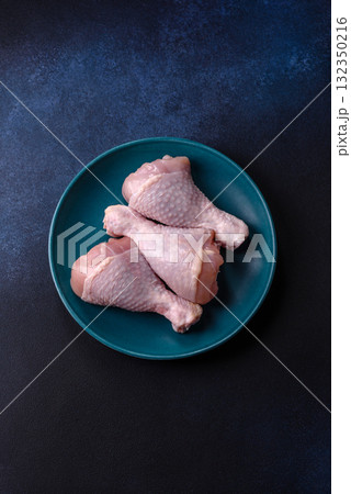 Raw chicken or turkey legs as a food background for cooking on a barbecue or grill. Chicken raw legs Raw chicken or turkey legs as a food background for cooking on a barbecue or grill. Chicken raw legs 132350216