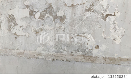 Peeling paint and stains on white wall due to water seepage damage Peeling paint and stains on white wall due to water seepage damage 132350284