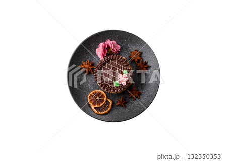 Sweet tart, pie with chocolate and cream with fruit filling on a plate. Chocolate tart Sweet tart, pie with chocolate and cream with fruit filling on a plate. Chocolate tart 132350353