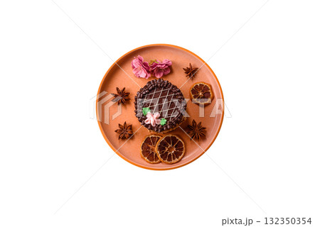 Sweet tart, pie with chocolate and cream with fruit filling on a plate. Chocolate tart 132350354