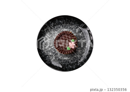 Sweet tart, pie with chocolate and cream with fruit filling on a plate. Chocolate tart 132350356