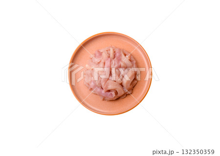 Raw chicken meat cut into strips, fresh fillet or breast slices. Chicken raw meat in pieces 132350359