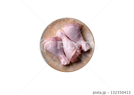 Raw chicken or turkey legs as a food background for cooking on a barbecue or grill. Chicken raw legs Raw chicken or turkey legs as a food background for cooking on a barbecue or grill. Chicken raw legs 132350413