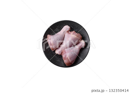 Raw chicken or turkey legs as a food background for cooking on a barbecue or grill. Chicken raw legs Raw chicken or turkey legs as a food background for cooking on a barbecue or grill. Chicken raw legs 132350414