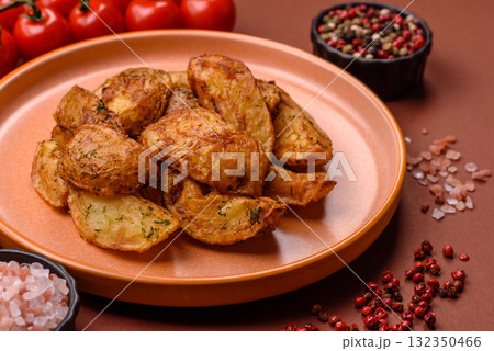 Potato wedges baked with spices, garlic and rosemary. Potato wedges Potato wedges baked with spices, garlic and rosemary. Potato wedges 132350466