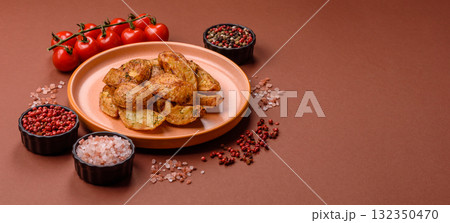Potato wedges baked with spices, garlic and rosemary. Potato wedges Potato wedges baked with spices, garlic and rosemary. Potato wedges 132350470