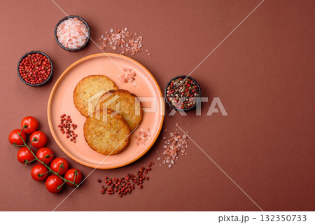 Hash browns, fried potato and onion pancakes with spices for breakfast. Fried hash browns Hash browns, fried potato and onion pancakes with spices for breakfast. Fried hash browns 132350733