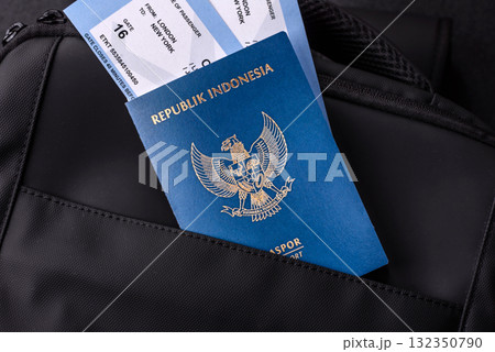 Indonesia passport, visa for travel, document with tickets in travel bag. Indonesian passport Indonesia passport, visa for travel, document with tickets in travel bag. Indonesian passport 132350790