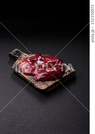 Raw fresh chicken or turkey liver, internal offal of poultry. Raw chicken liver Raw fresh chicken or turkey liver, internal offal of poultry. Raw chicken liver 132350972