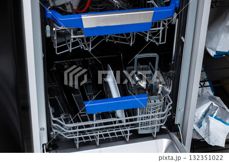 Modern Dishwasher Loaded with Clean Kitchenware and Cutlery 132351022