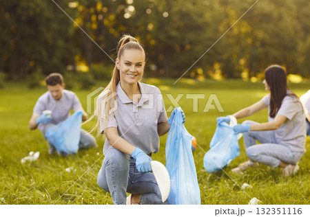 Picking up trash cleaning green park, group friends people working, wearing blue gloves, bags 132351116