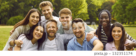 Group portrait of happy cheerful young diverse friends together in green summer park 132351174