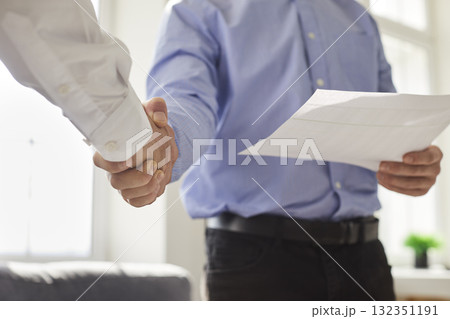 Two business people cooperate, meet in the office, make a deal and exchange handshakes 132351191