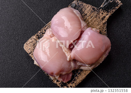 Chicken or turkey raw thigh fillet, skinless and boneless poultry meat. Chicken thigh fillet Chicken or turkey raw thigh fillet, skinless and boneless poultry meat. Chicken thigh fillet 132351558