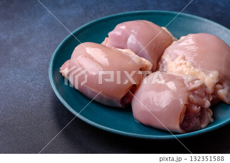 Chicken or turkey raw thigh fillet, skinless and boneless poultry meat. Chicken thigh fillet Chicken or turkey raw thigh fillet, skinless and boneless poultry meat. Chicken thigh fillet 132351588