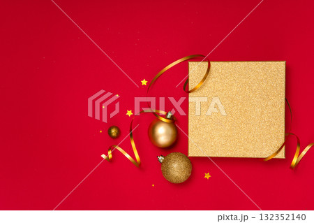 Horizontal background with golden gift box lid, baubles, ribbon and confetti. Great template for banner, header or sale promo. Horizontal background with golden gift box lid, baubles, ribbon and confetti. Great template for banner, header or sale promo. 132352140