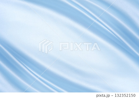 Glossy satin folds in light blue with diagonal flow and highlights. Luxury background for cosmetics, weddings and holiday branding. 132352150