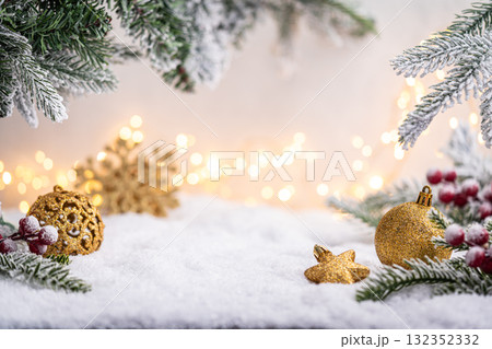 Gold Christmas Ornaments on Snow with Frosted Pine and Berries Gold Christmas Ornaments on Snow with Frosted Pine and Berries 132352332