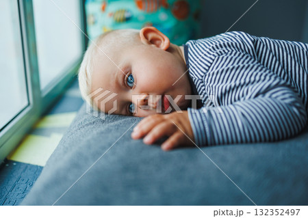 Blond baby crawling on the floor at home. Child development. Boy learning to crawl. Blond baby crawling on the floor at home. Child development. Boy learning to crawl. 132352497
