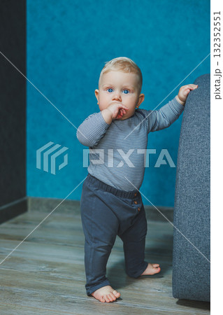 A Curious Toddler Standing in a Modern and Stylish Interior Space that is Brightly Designed A Curious Toddler Standing in a Modern and Stylish Interior Space that is Brightly Designed 132352551