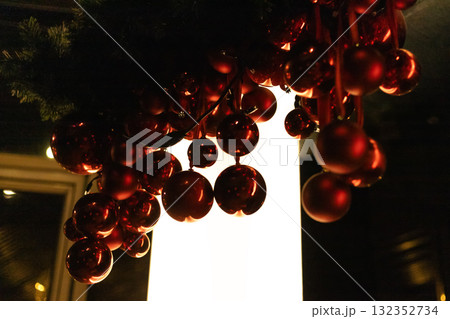 Red Christmas ornaments decorating the canopy of a house during the holiday season Red Christmas ornaments decorating the canopy of a house during the holiday season 132352734