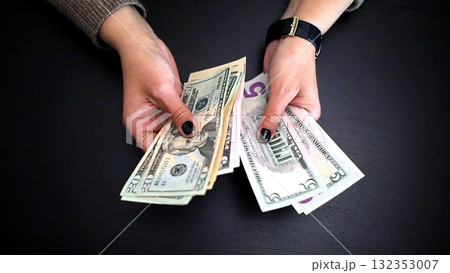 Woman counting money for savings and expenses 132353007