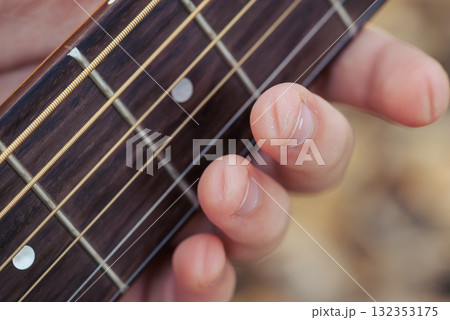 Playing long time the guitar, prints of strings on fingers. Close up of hand of guitarist woman with traces of strings on her fingers 132353175